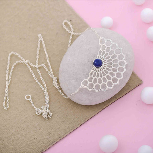Intricate sterling silver necklace with a vibrant blue lapis lazuli stone, elegant and healing jewelry for everyday wear.
