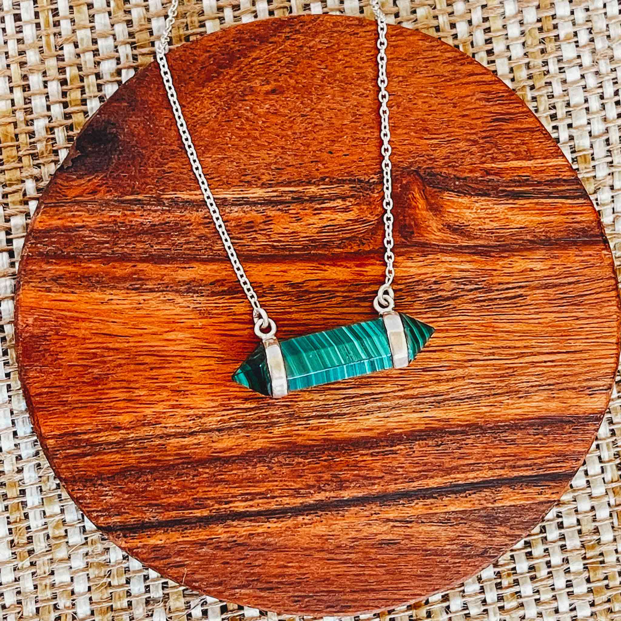 Playful sterling silver necklace with a bold green malachite gemstone, perfect for layering or statement looks.