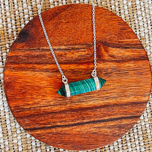 Playful sterling silver necklace with a bold green malachite gemstone, perfect for layering or statement looks.